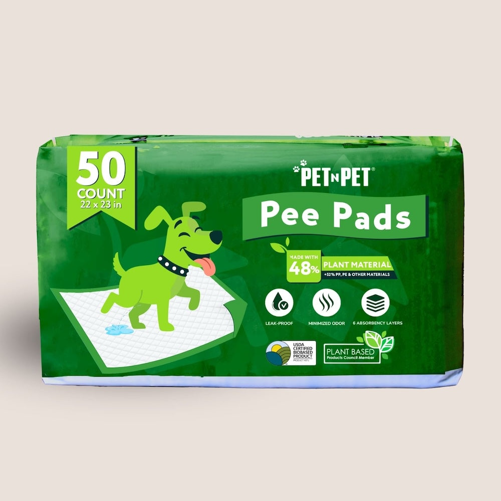 Package of PetNPet pee pads with green design and text on a beige background