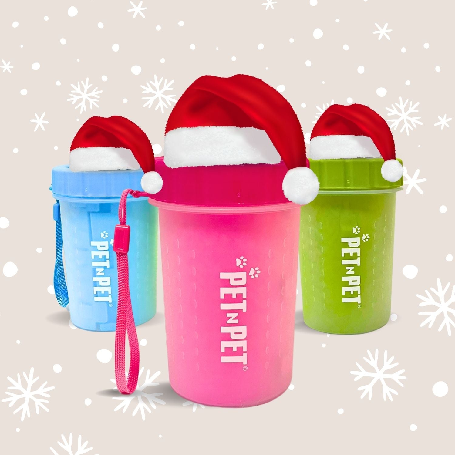 Three colorful pet water bottles with Santa hats on a snowy background