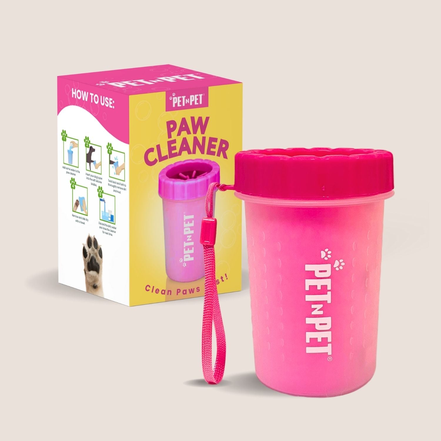 Pink paw cleaner with packaging on a light beige background